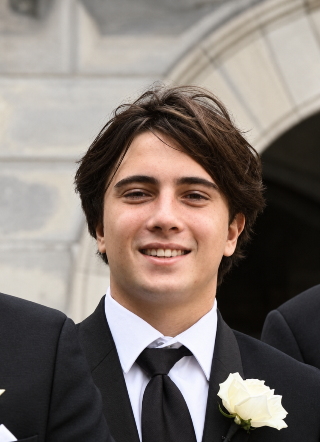 Lucas Erikson smiling in a suit